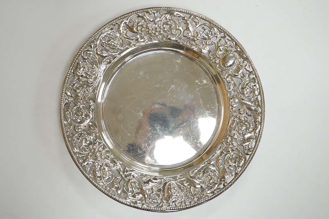 A late Victorian shallow dish or stand, by William Comyns, with pierced foliate border, decorated with masks and birds, London, 1898, diameter 23.1cm, 11.4oz.